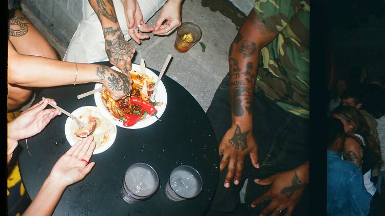 People eating food on a low black table