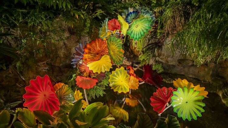 Flower sculptures in mossy garden 