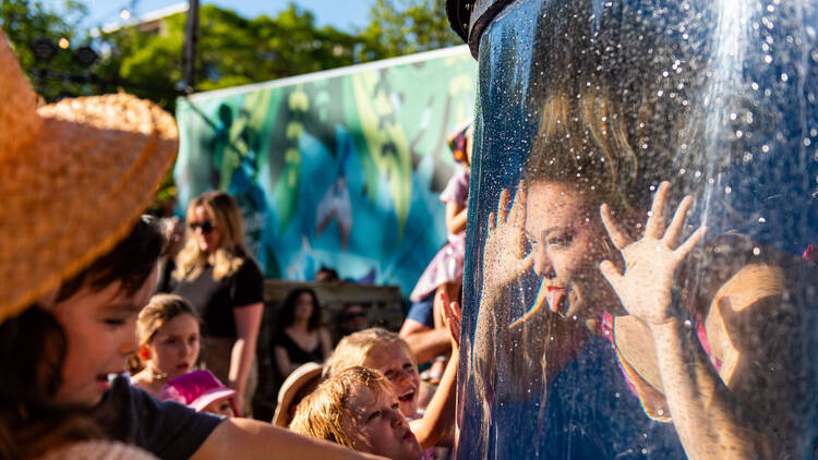 Woman in tank poking tongue out at crowd