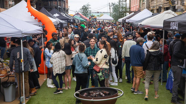 A crowd of people standing outside at Industry City for Blocktoberfest