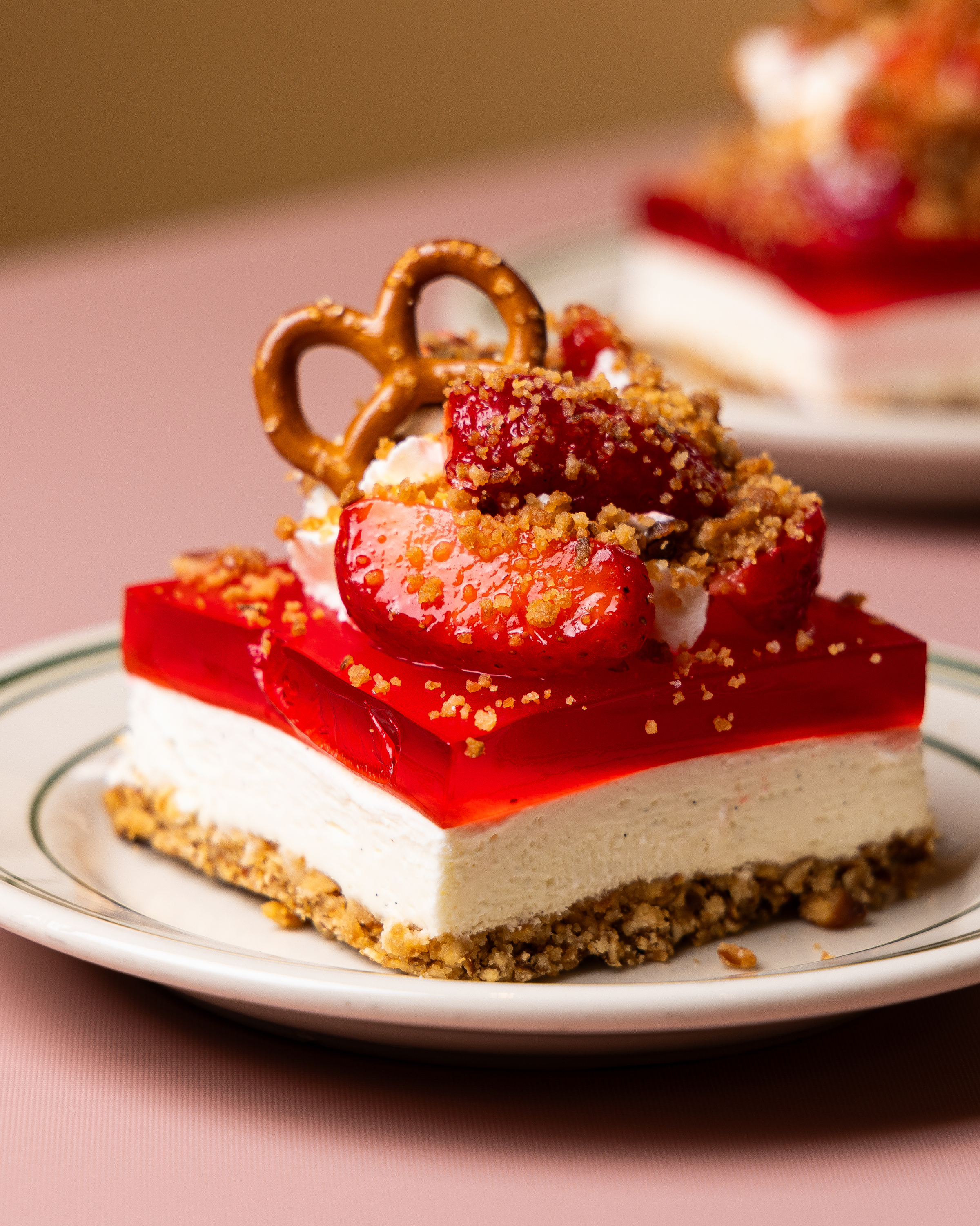 Strawberry Pretzel Salad desser tiwht cheesecake, strawberries and pretzels on top