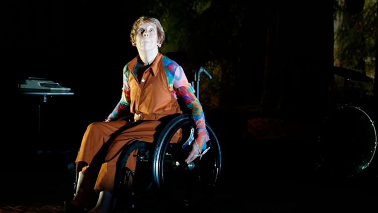 Melinda Smith sits in her wheelchair wearing a colourful outfit