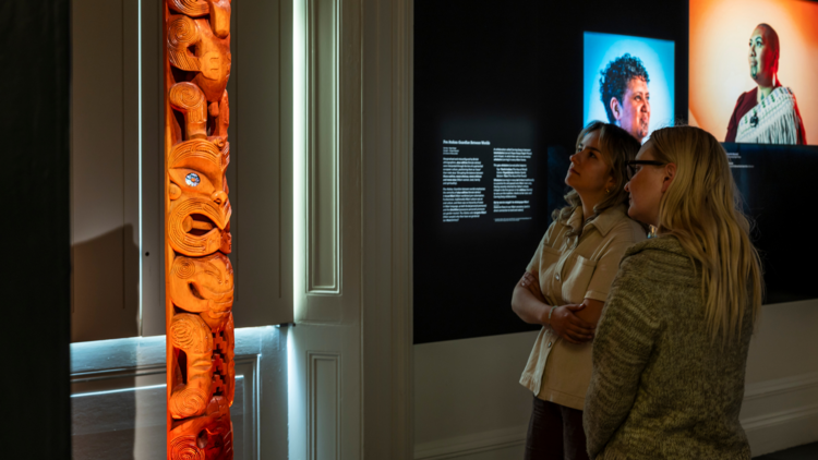 Portraits of Maori women and a carved pole