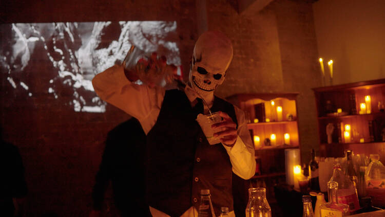 A skelton making drinks