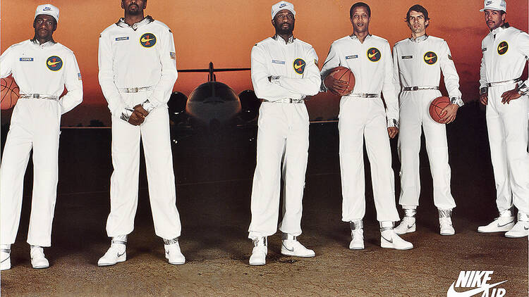 A group of basketball players next to a plane.