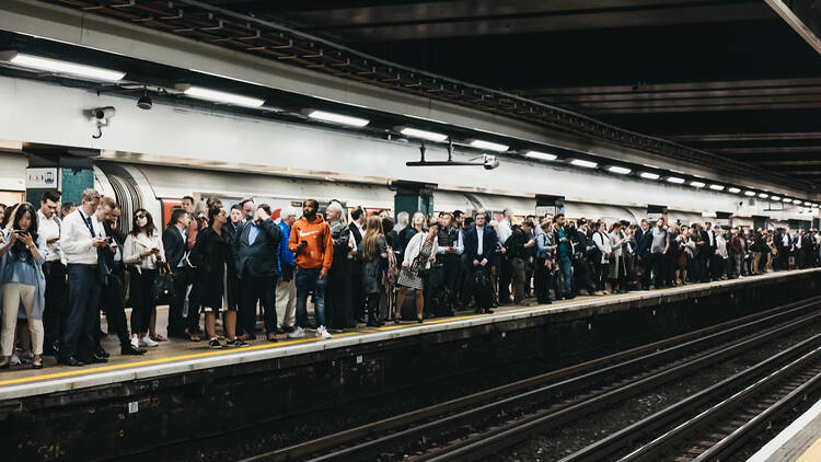 Busy London train platform with crowd of commuters at Moorgate