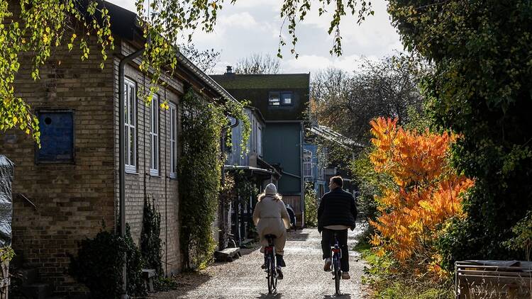 A young couple riding bikes in autumn in Copenhagen, Denmark