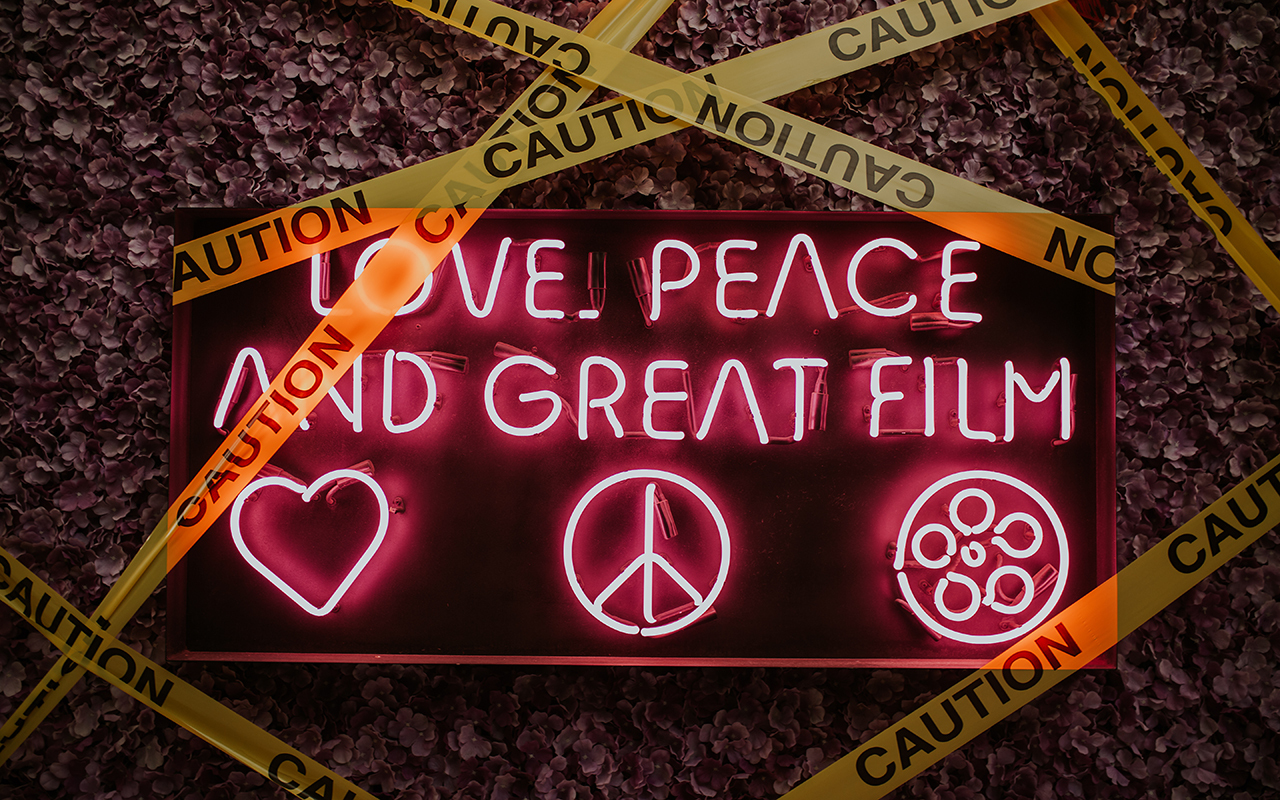 A sign reading love peace and great film. 