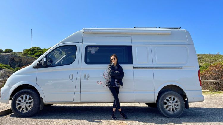 Girl standing in front of caravan