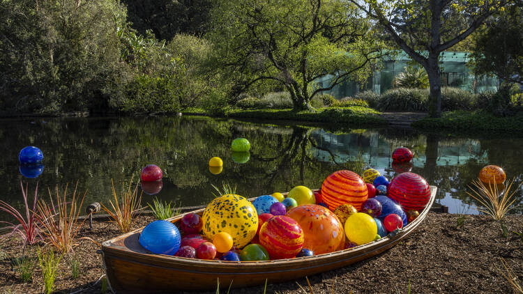 Boat with red glass balls by lake