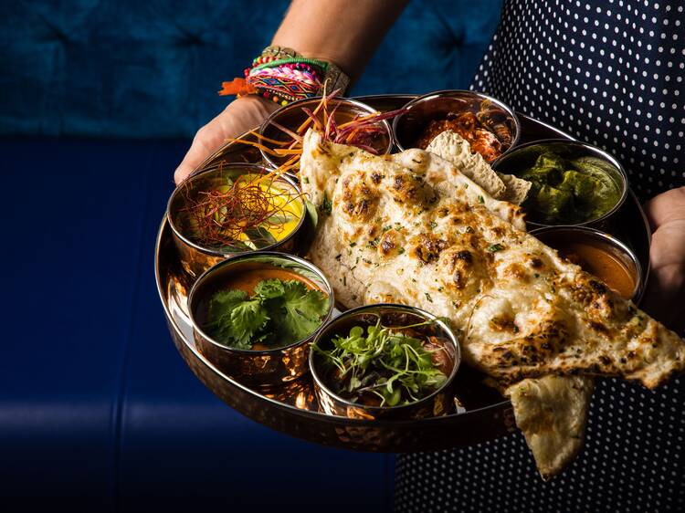 Thali with curry pots and naan