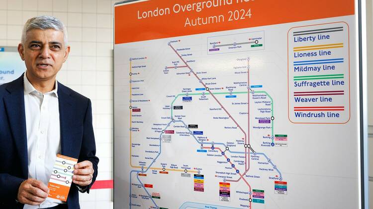 London Mayor Sadiq Khan with a map of the new Overground lines