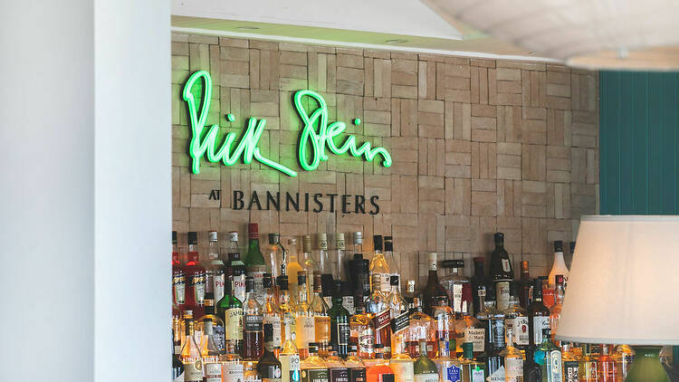 Bar with neon green sign saying 'Rick Stein'