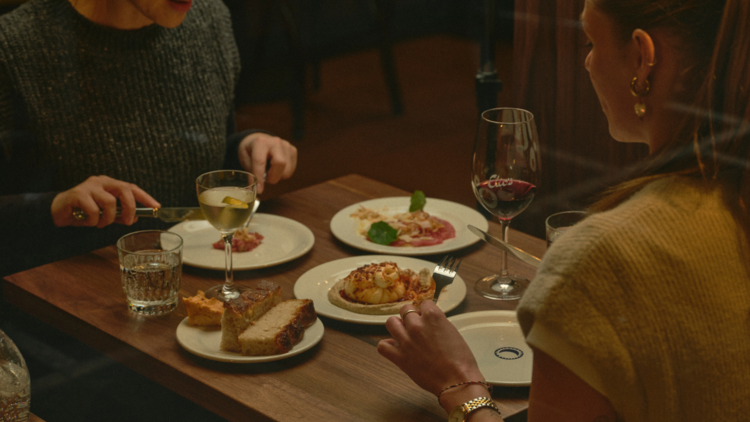 Pair of diners at Elio's Place sitting down to a meal.