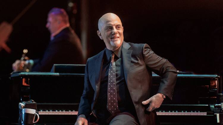 Billy Joel at his piano on stage 