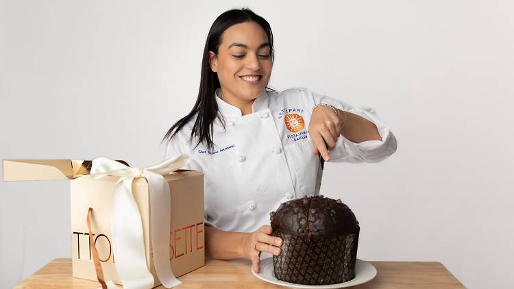 Bilena Settepani of Settepani Bakery cutting into a chocolate panettone