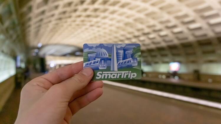 A person holds up a SmarTrip card in Washington, D.C.