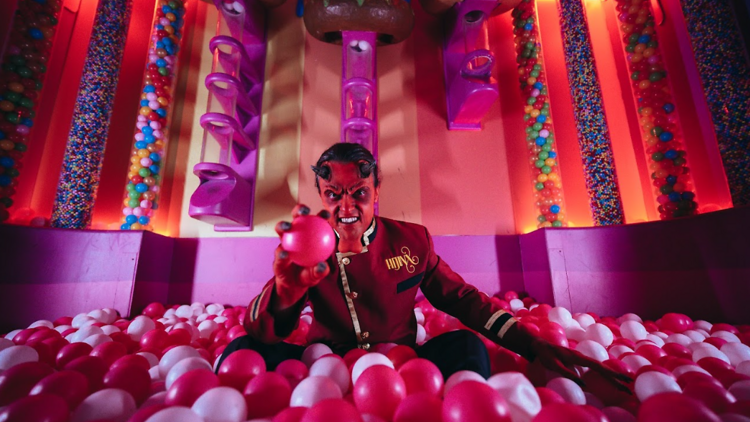 Person dressed as devil in a ball pit