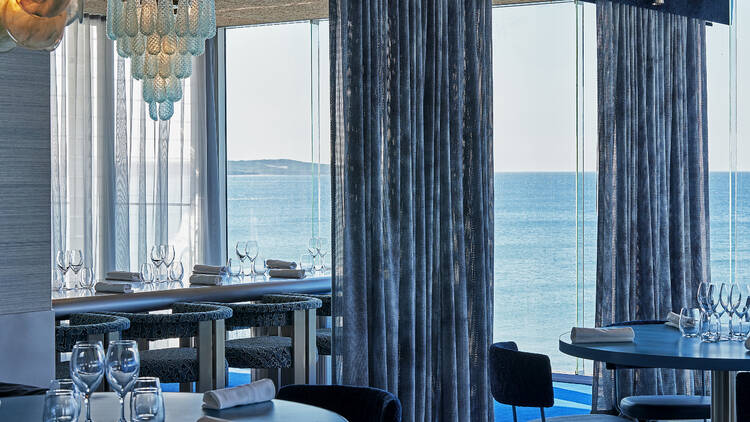 Interior of a fancy restaurant with views of the water