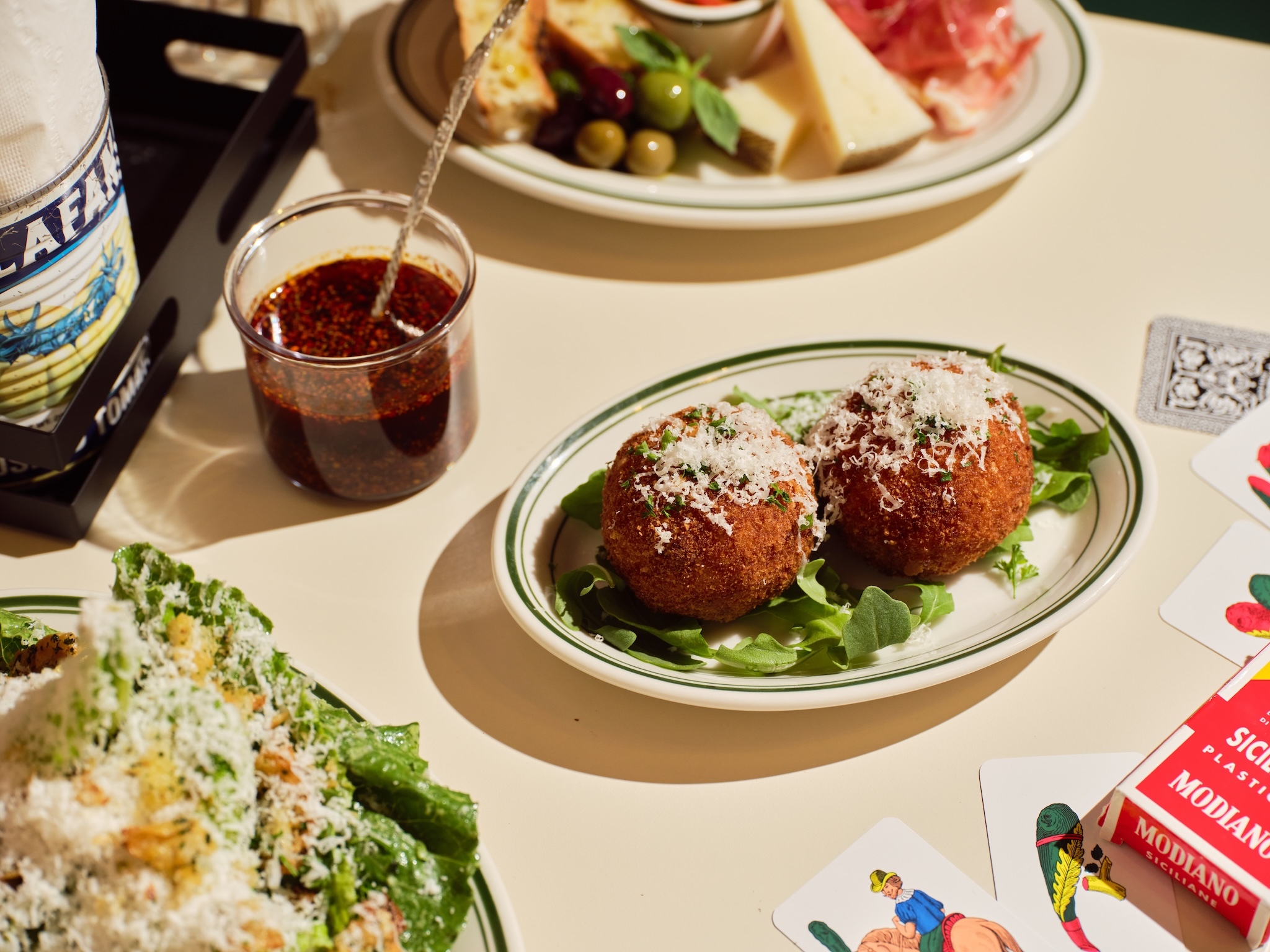 Arancini on a plate covered with cheese