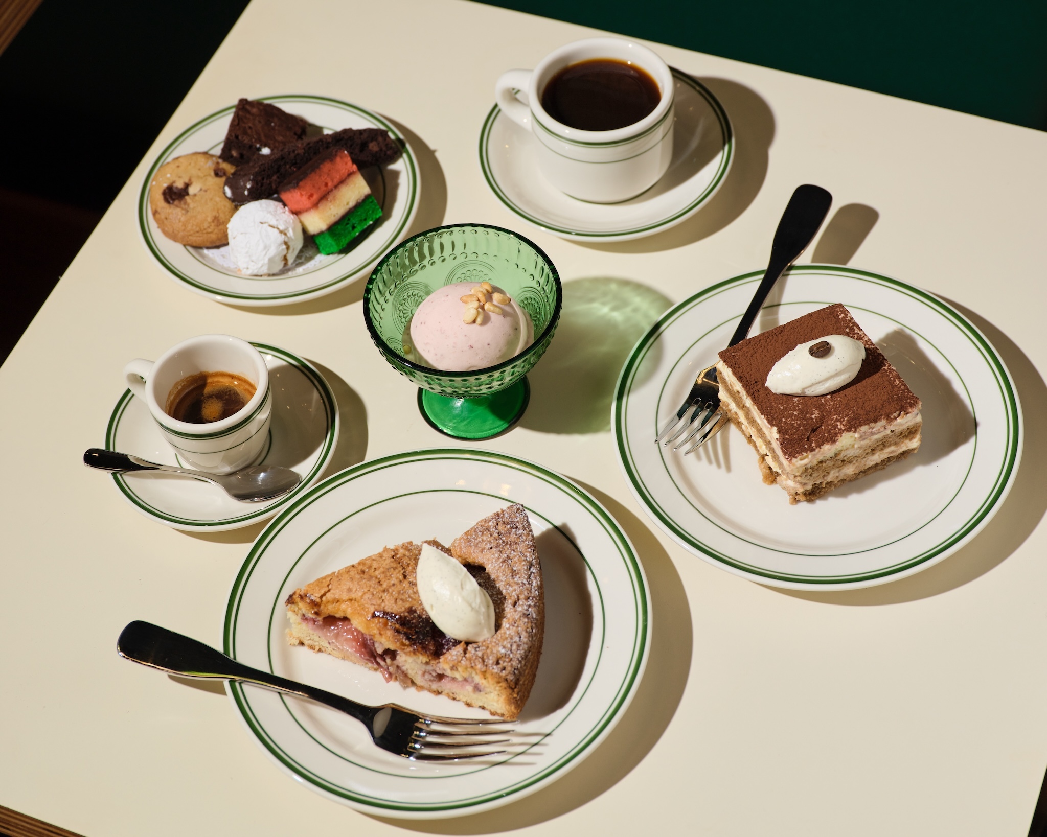 A table full of desserts including pie, tiramisu and gelato