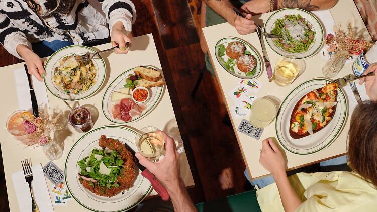 An overhead shot of two tables filled with Italian food