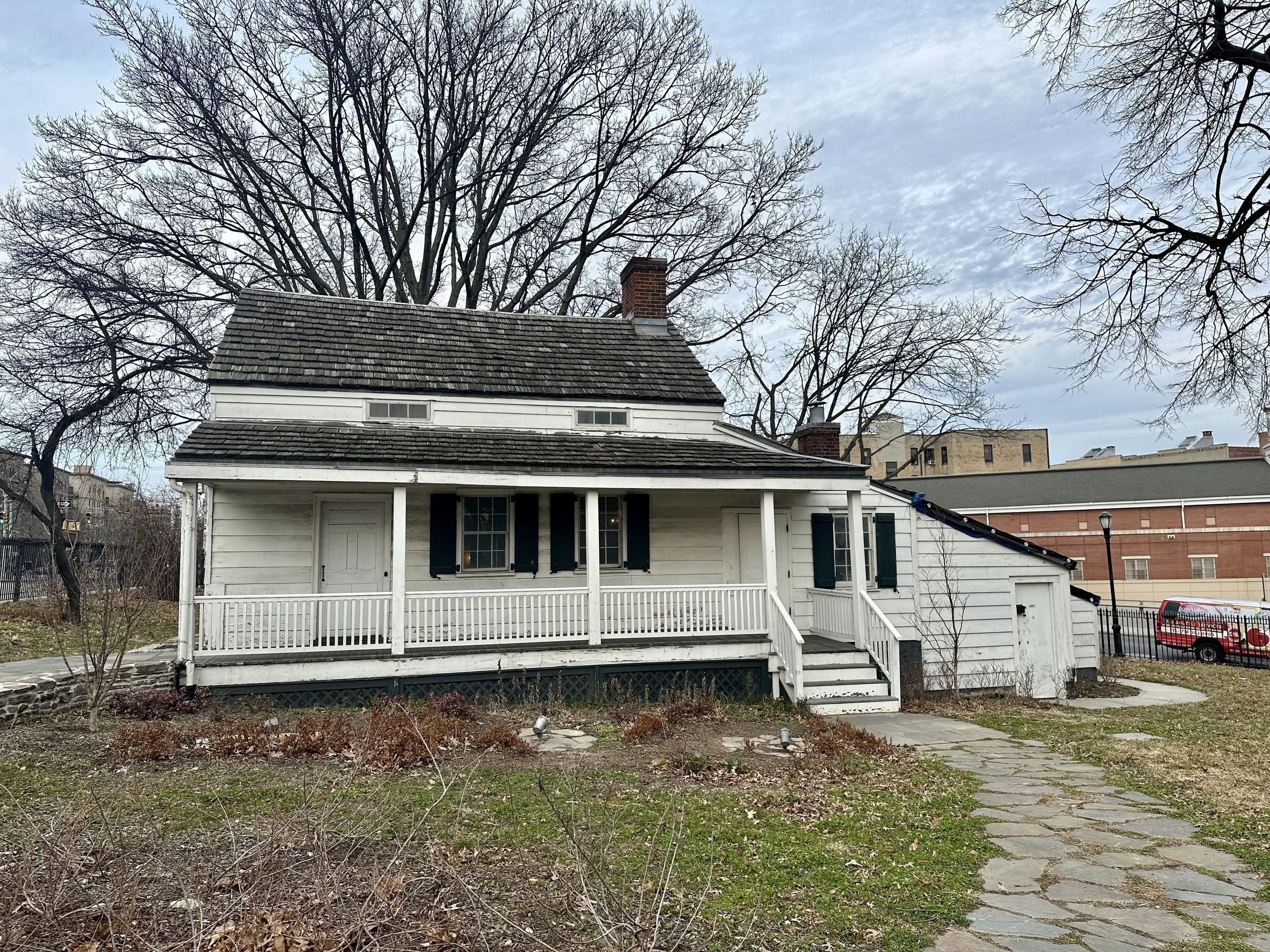 The exterior of Edgar Allan Poe's cottage in the Bronx, a small white building.