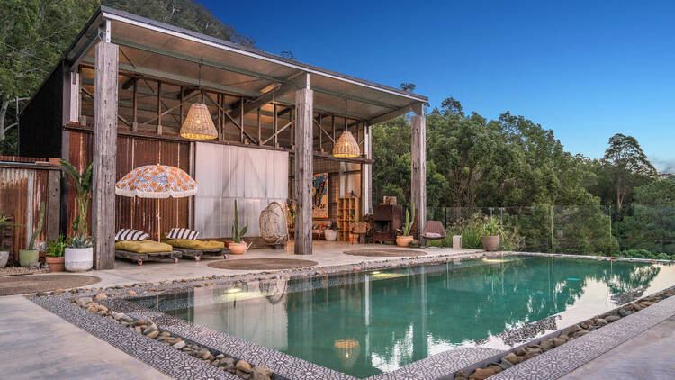 Pool with cabana and sun lounges