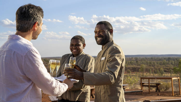 Waiters serving Champagne in desert