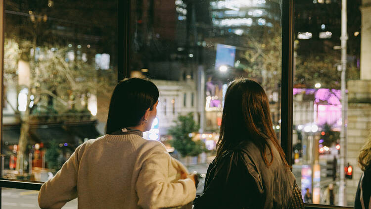 Friends looking out into the city streets from Springrock.