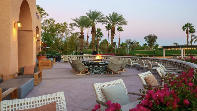 Terrace with sun loungers and a fire pit area