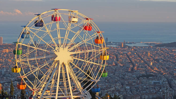 The ferris wheel at Tibidabo theme park, with a view of Barcelona and the sea in the background