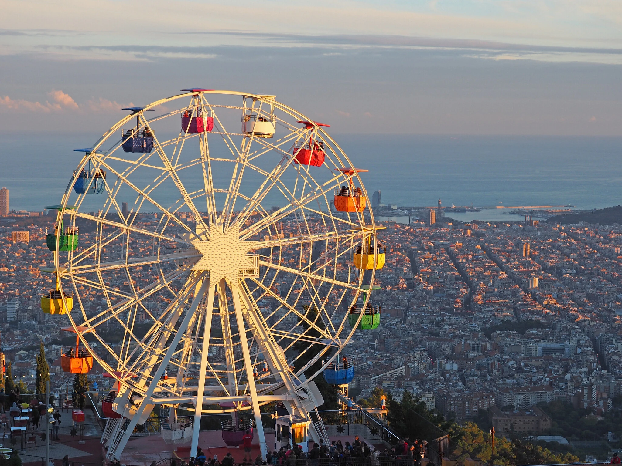The ferris wheel at Tibidabo theme park, with a view of Barcelona and the sea in the background