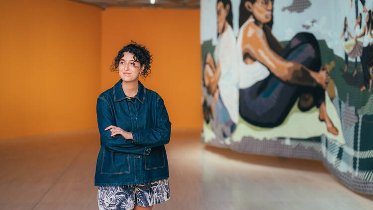 Woman standing in front of art exhibition