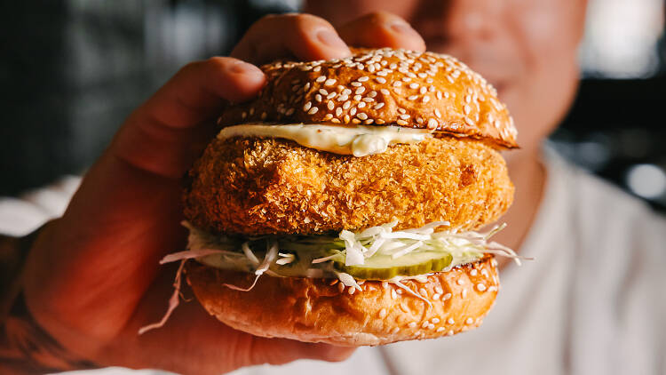 A man holding Nowon's version of a Krabby Patty 