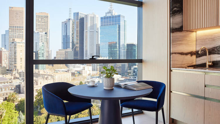 A dining area overlooking Melbourne CBD at Lanson Place Parliament Gardens.