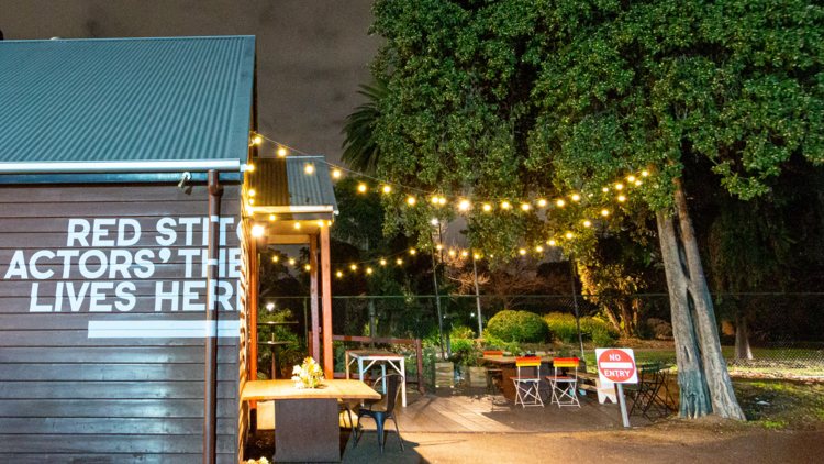 Side view of red stitch at night lit by festoons