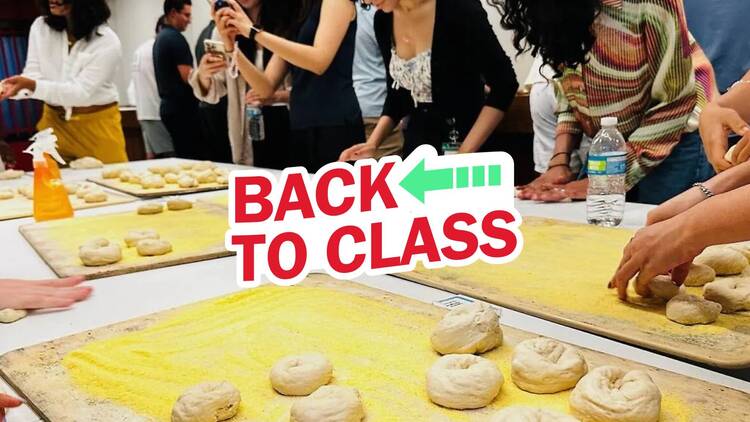 People handroll bagels during a class.