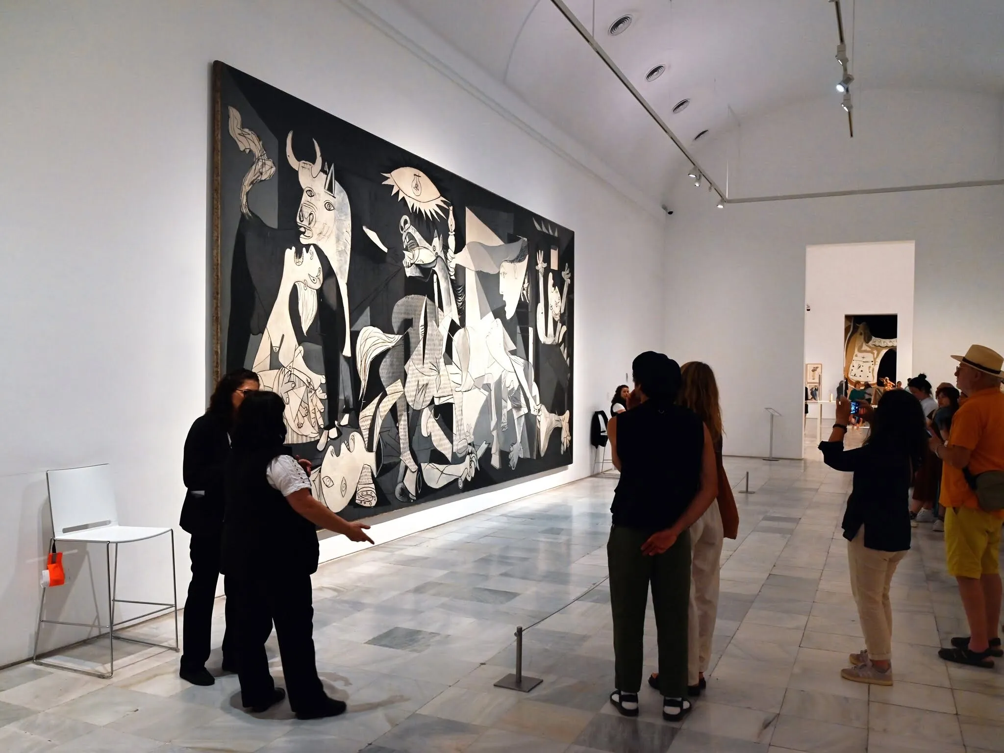 Madrid, Spain, june 6, 2024 : Visitors in front of Pablo Picasso painting Guernica painted in 1937 exhibited at the Reina Sofia Museum in Madrid