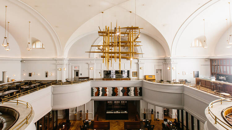 The mezzanine of the hotel with modern brass lights.