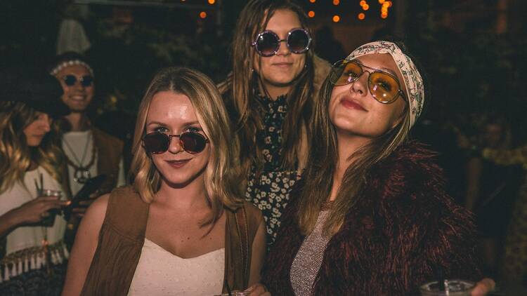 Partygoers dressed in hippie attire at HollyWoodstock.