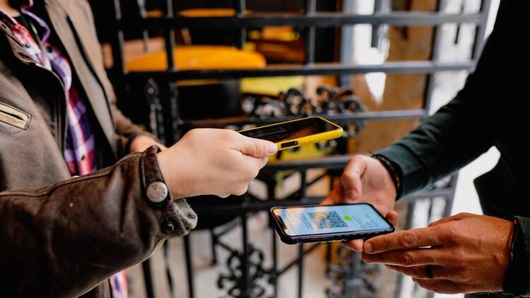 People scanning boarding passes on a phone