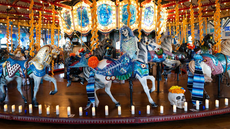 A Day of the Dead skeleton sits on the carousel at the Santa Monica Pier.