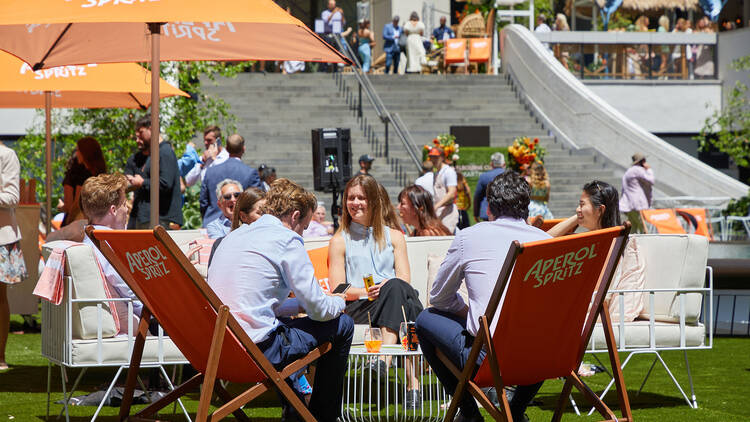 People sitting outside in deck chairs