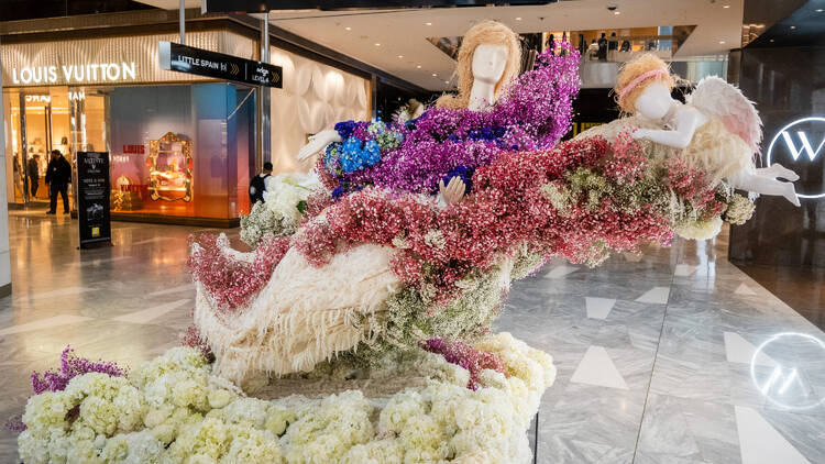 A floral sculpture with purple and pink flowers.