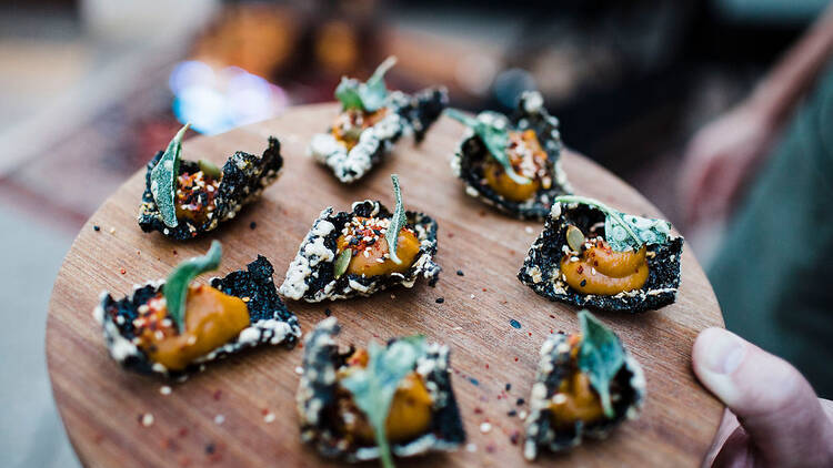 Canapes with orange sauce and leaf