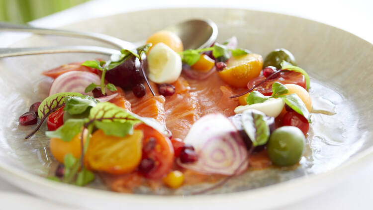 Sashimi with fresh herbs and tomatoes