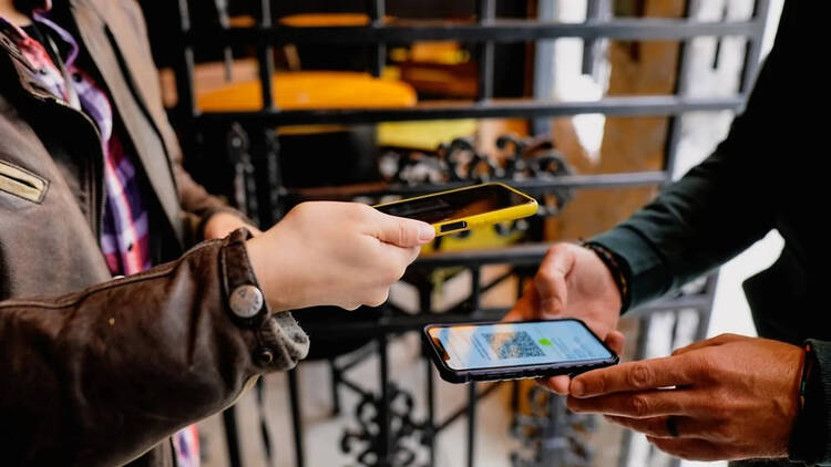 People scanning boarding passes on a phone