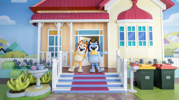 Bluey and Bingo characters outside house