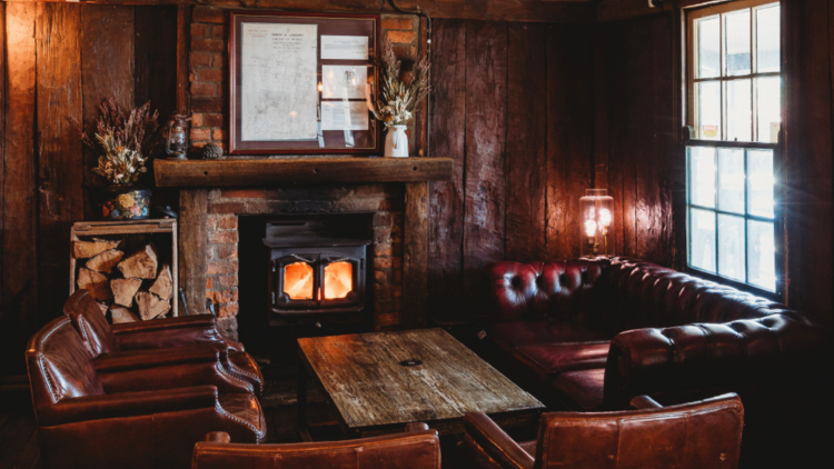 Lounge room with red sofas and fireplace